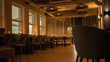 Cozy restaurant interior with warm lighting.