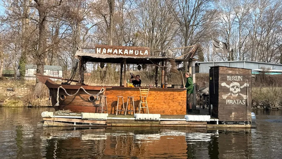 Wooden raft bar floating on a river.