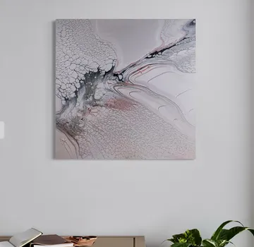 Abstract painting hangs on simple white wall.