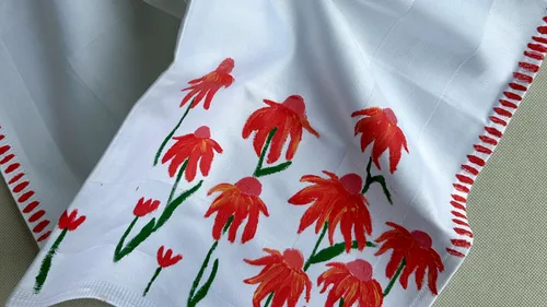 Hand-painted napkin with red flowers design.