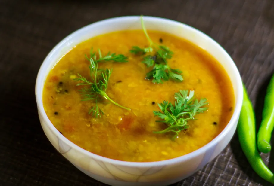 Yellow lentil soup with cilantro in a bowl.