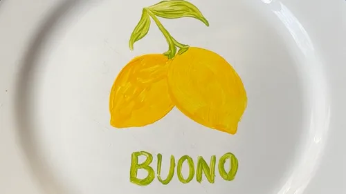 Painted lemons with 'Buono' on plate.