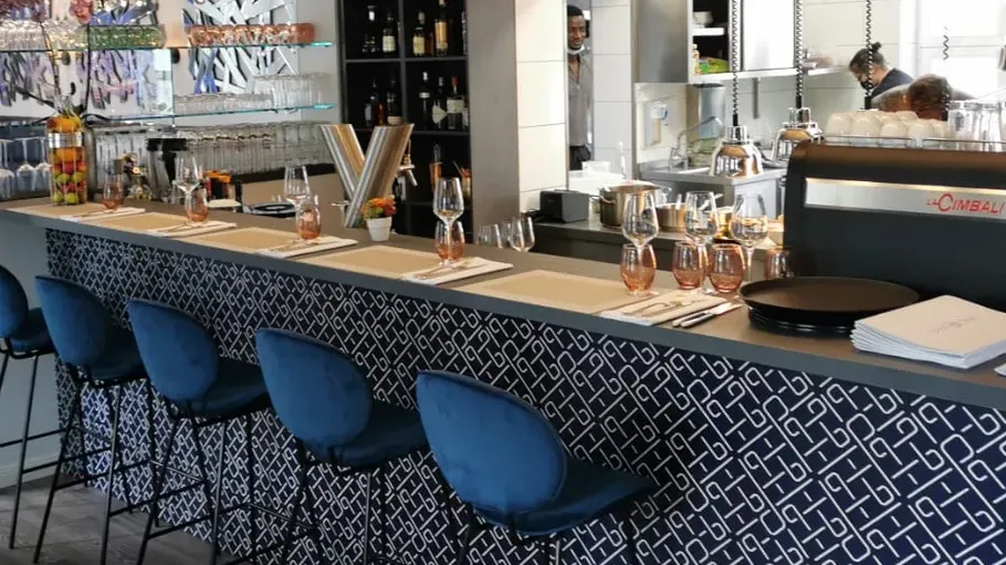 Stylish bar interior with blue chairs.