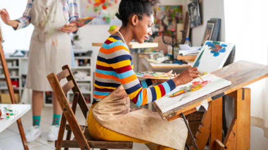 Woman painting in a bright art studio.