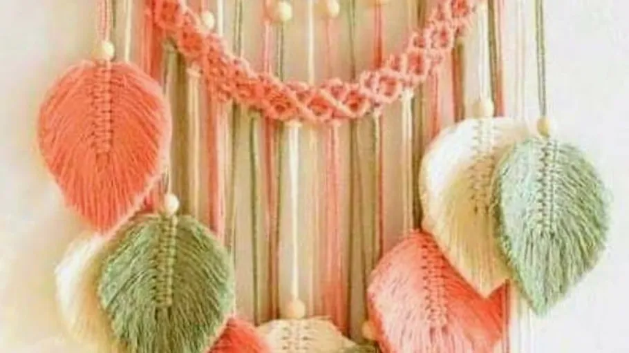 Colorful macramé leaves hanging on wall.