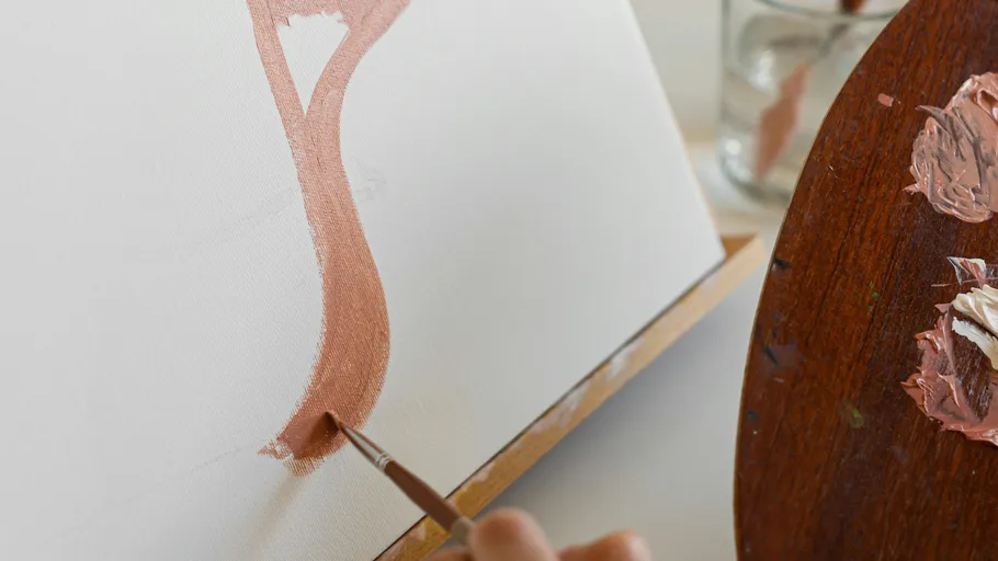 Hand painting on canvas with brush and palette.