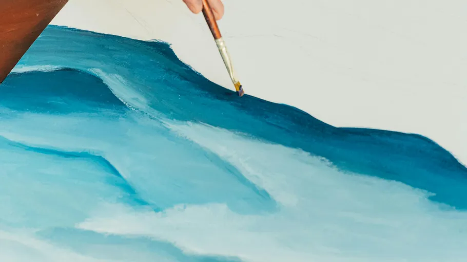 Hand painting ocean waves on canvas.