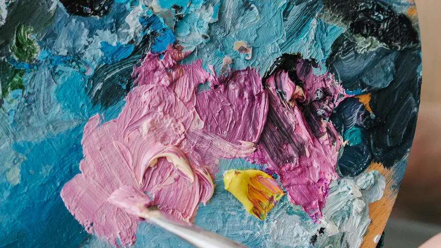 Colorful paint palette with mixed pigments.