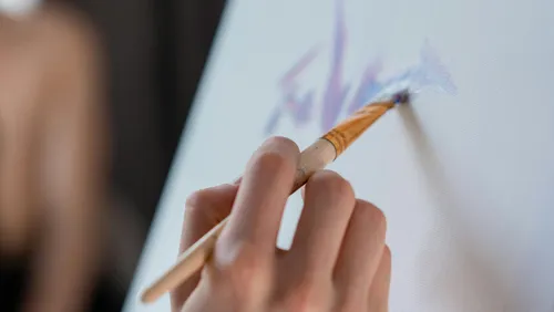 Hand painting on canvas with brush.