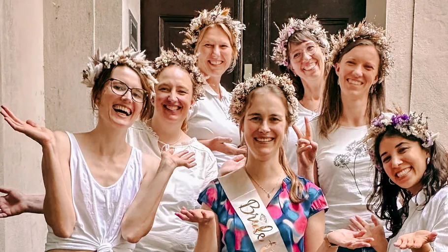 Group of women wearing flower crowns smiling.