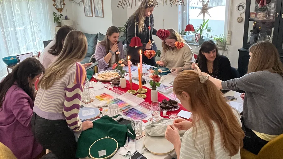 Group crafting at a festive table setting.