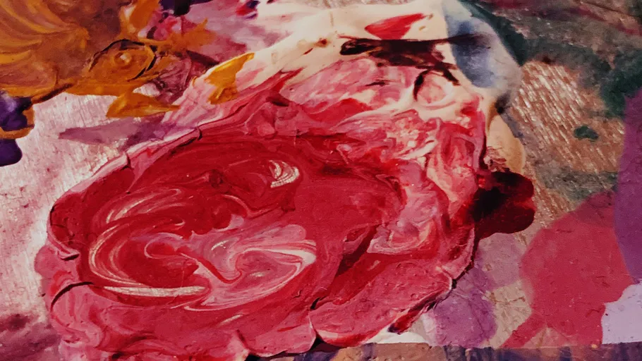 Abstract painting with red and colorful swirls.