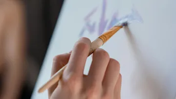 Hand painting on canvas with brush.