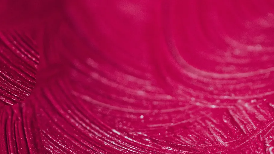 Close-up of pink fabric texture, swirling pattern.