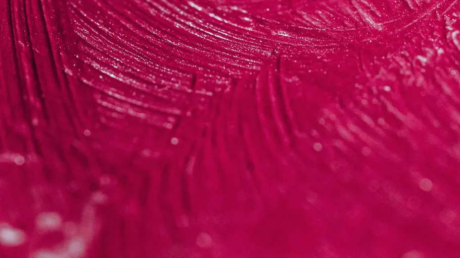 Close-up of red paint texture with brushstrokes.