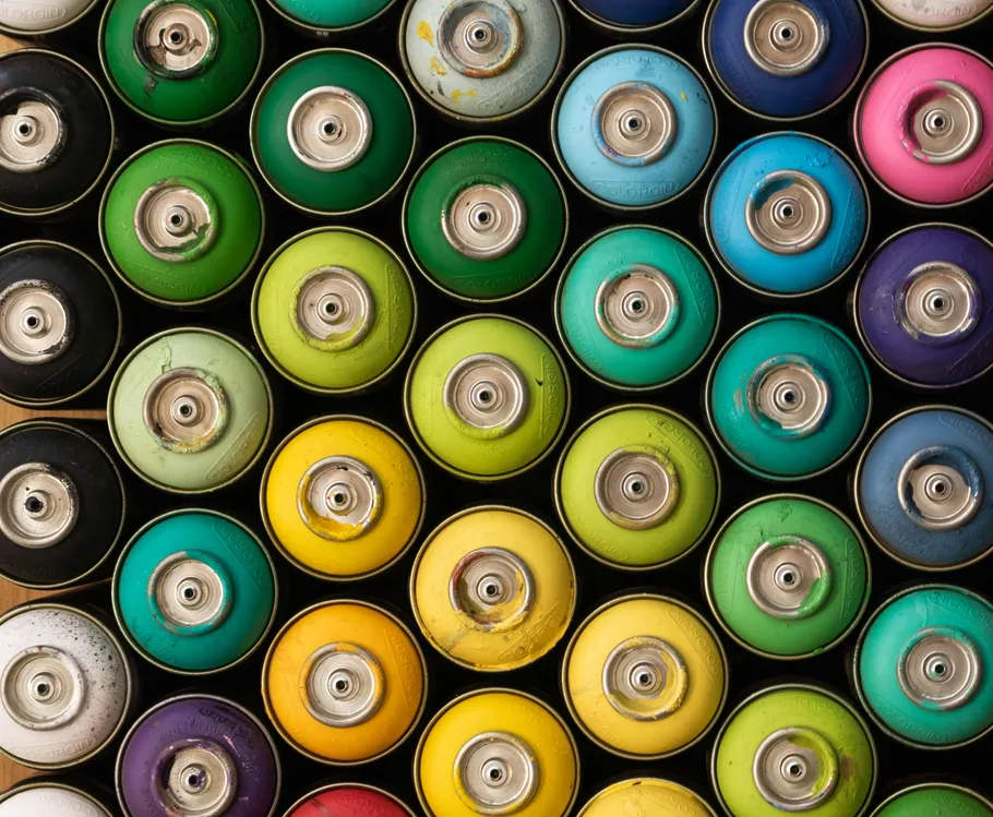 Colorful spray paint cans arranged neatly.