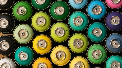 Top view of colorful spray paint cans.