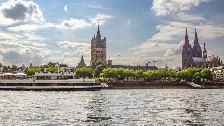 Boat on a river with cathedral background.