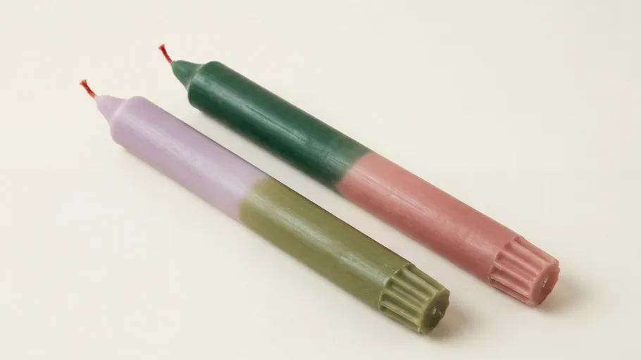 Two two-toned candles on a white background.