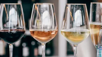 Three wine glasses with different wines.