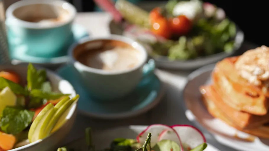 Breakfast dishes and coffee on a table.