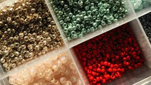 Multicolored beads in a compartmentalized box.