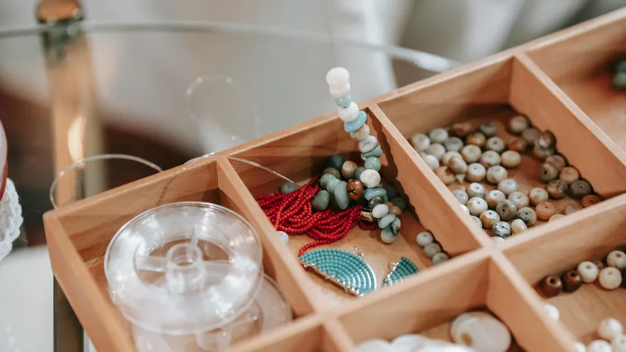Wooden box with various colorful beads.