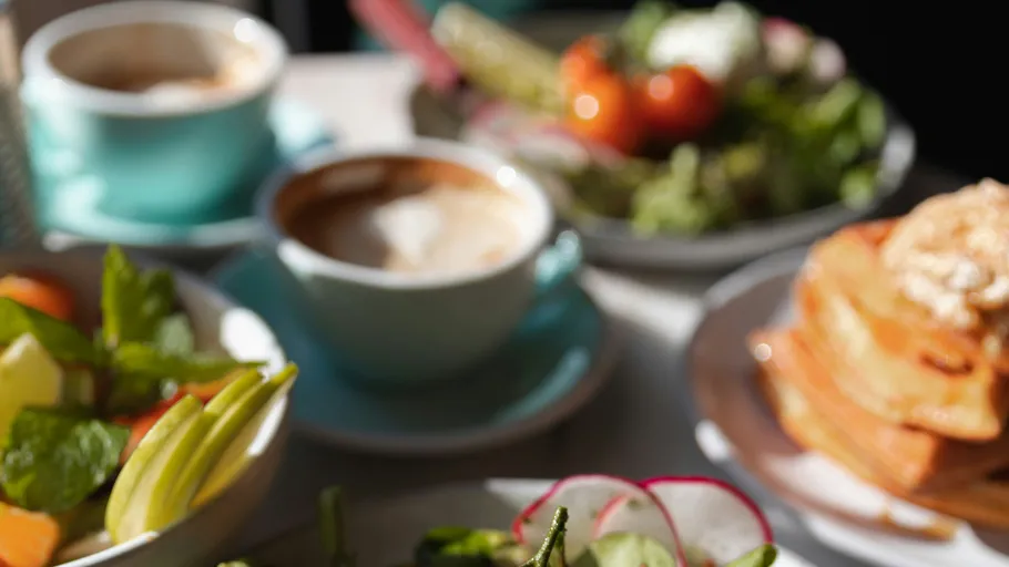 Breakfast dishes with coffee and pancakes displayed.