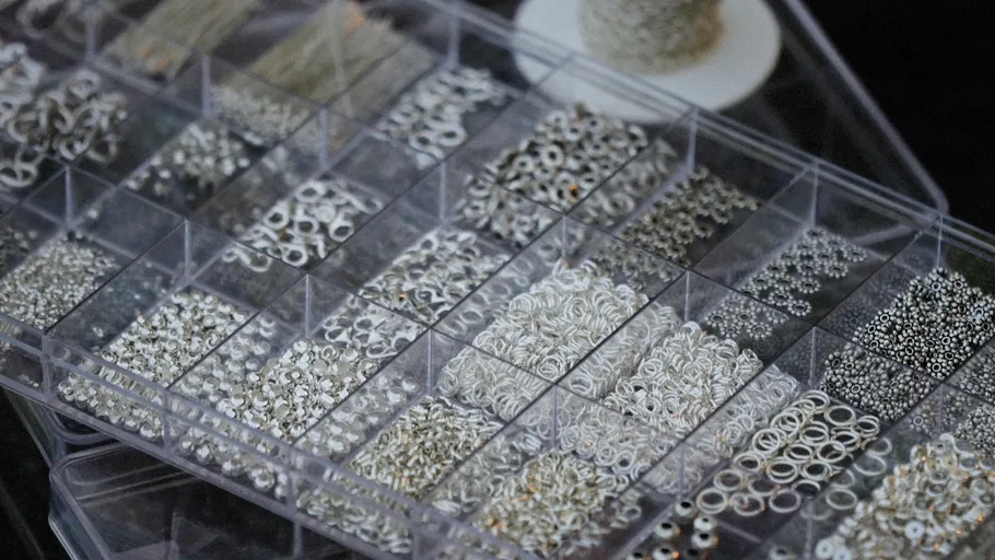 Box of assorted silver jewelry findings.