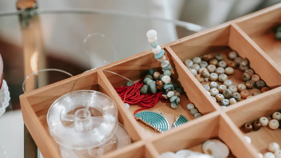 Wooden box with assorted colorful beads.