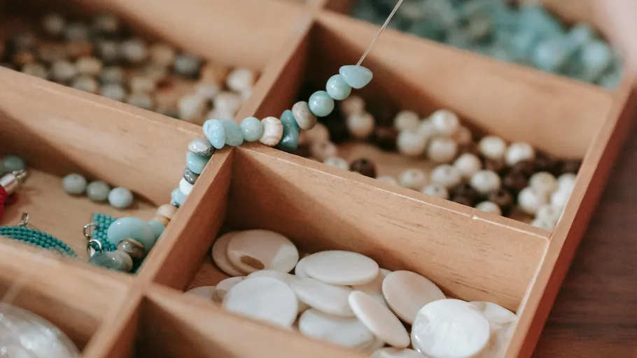 Tray with assorted beads being organized.
