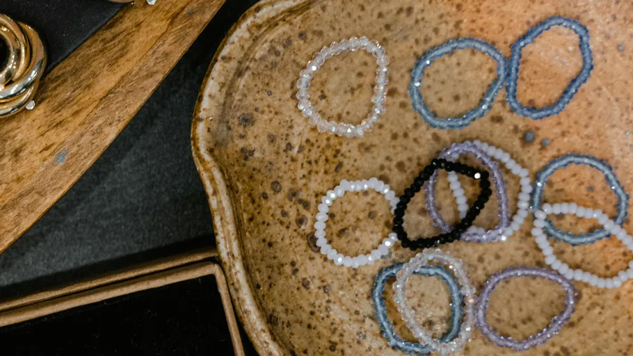 Beaded bracelets on a ceramic dish.