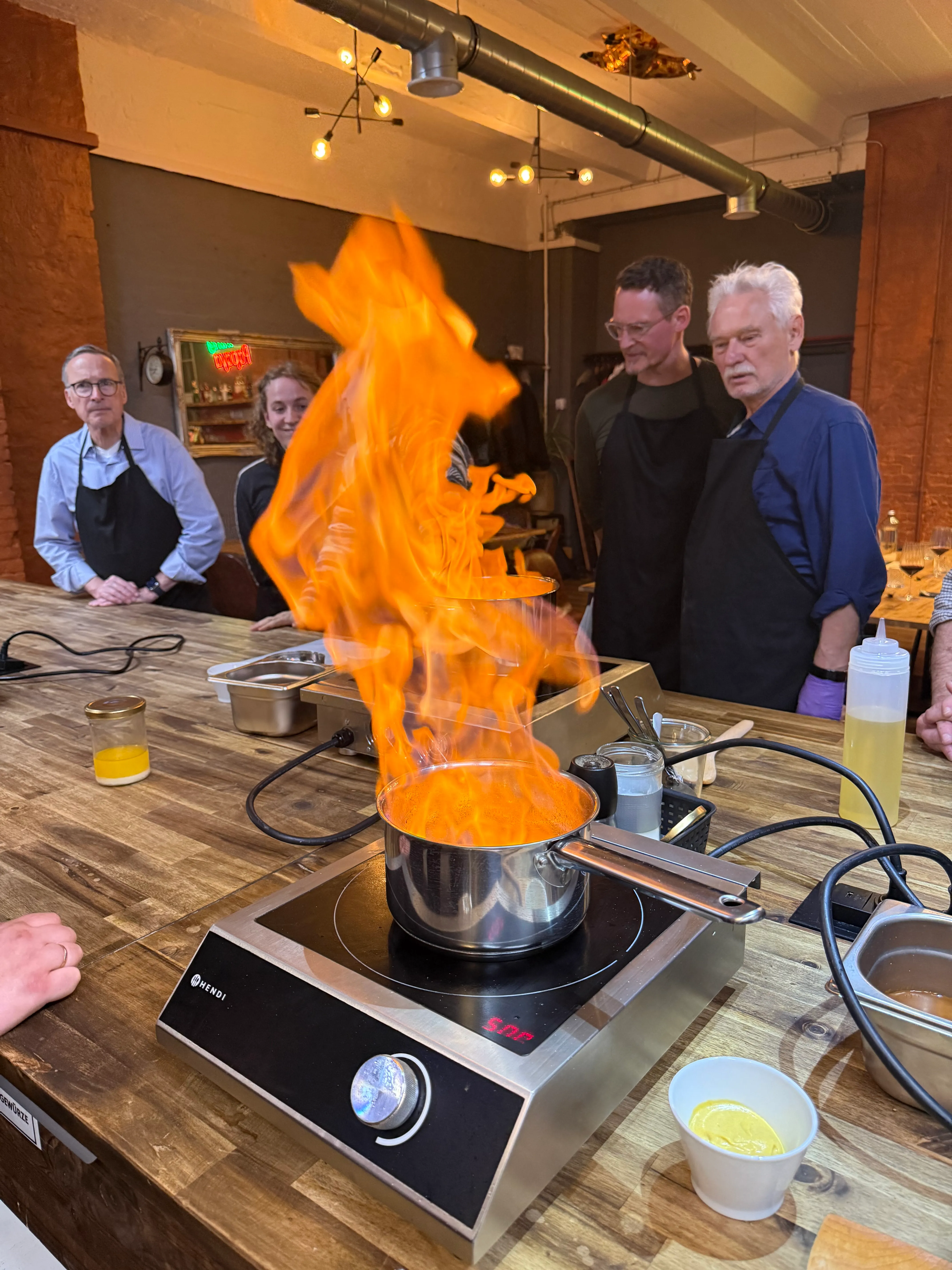 Flaming pot on stove in cooking class.