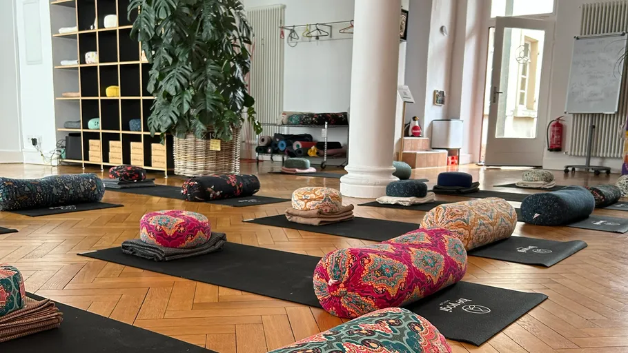 Yoga mats with cushions in a studio.