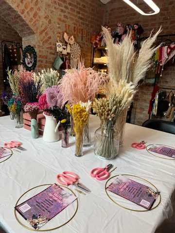 Basteltisch mit Trockenblumen und Scheren.