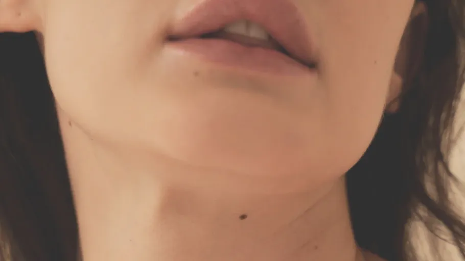 Close-up of woman's lips and chin.