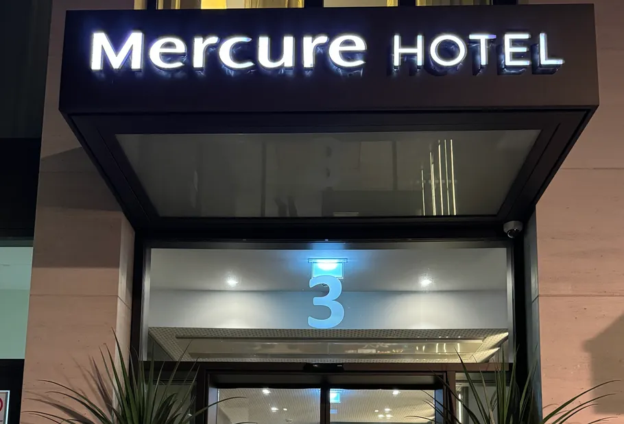 Mercure Hotel entrance under nighttime lighting.