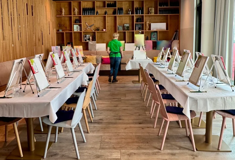 Person preparing art class in a modern room.