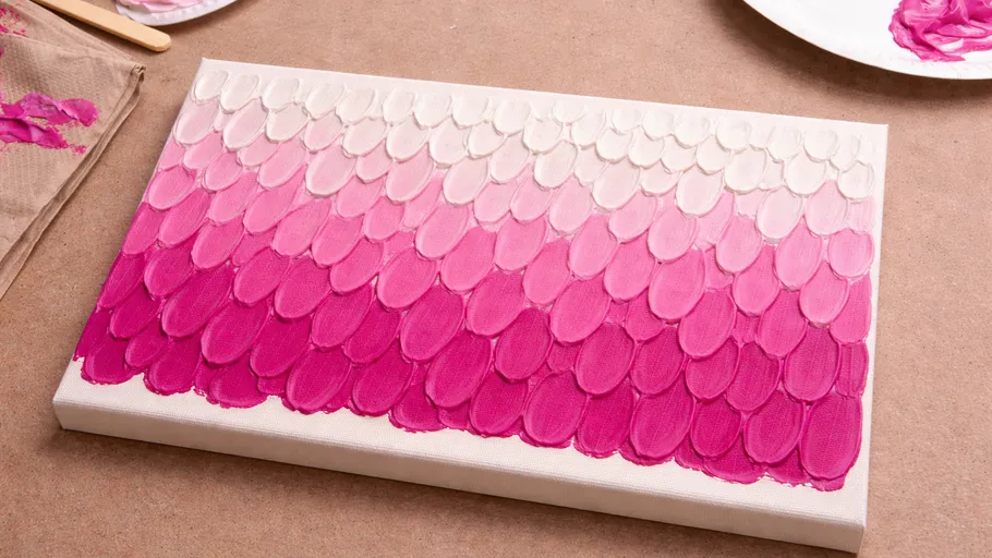 Canvas with pink gradient paint scales pattern.