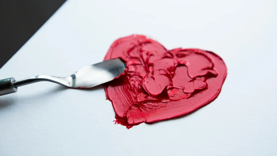 Red heart painted with palette knife on canvas.