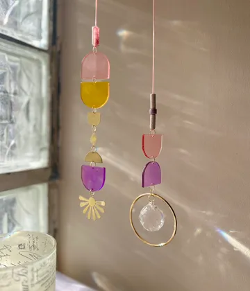 Colorful suncatchers hanging near a window.
