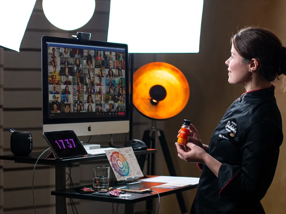Chef presents a drink during an online event.