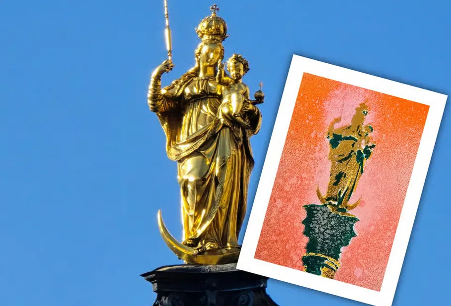 Golden statue of Mary and child against blue sky.