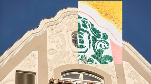 Decorative facade with abstract artwork overlay.