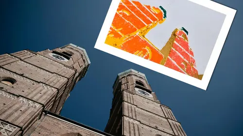 Towers with colorful painting against sky.