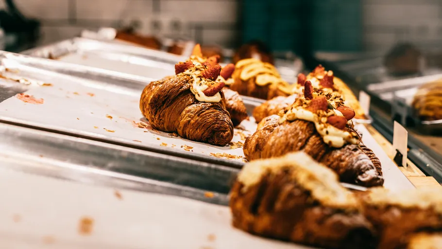 Decorated croissants on a bakery tray.