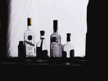 Bottles stand side by side against a bright background.