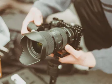 The camera is held in the hand by a person.