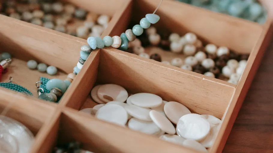 Wooden box with assorted colorful beads.