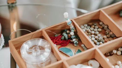 Wooden box with assorted colorful beads.